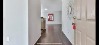A hallway with a painting on the wall.