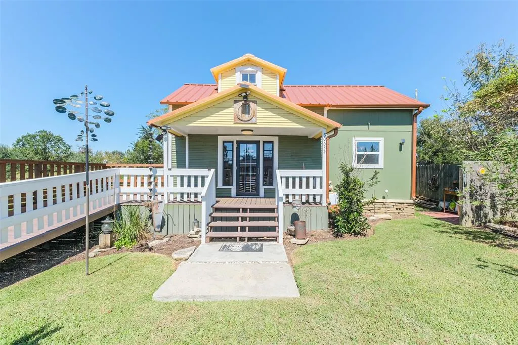 A house with a porch and steps leading to the front door.