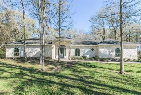 A white house with trees in the background