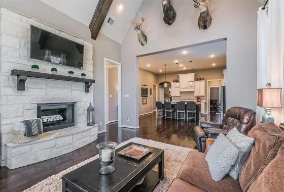 A living room with a fireplace and a large window.