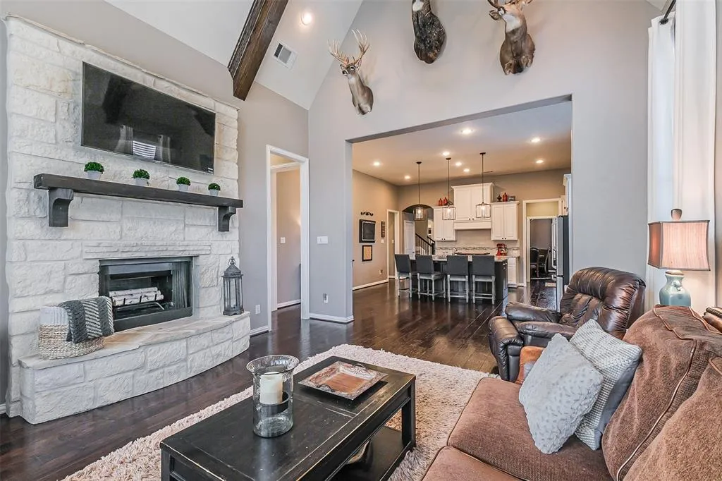 A living room with a fireplace and a large window.