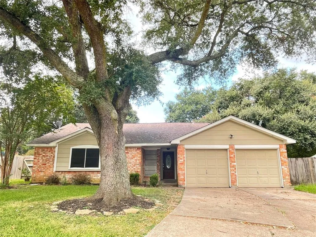 A large tree in front of a house