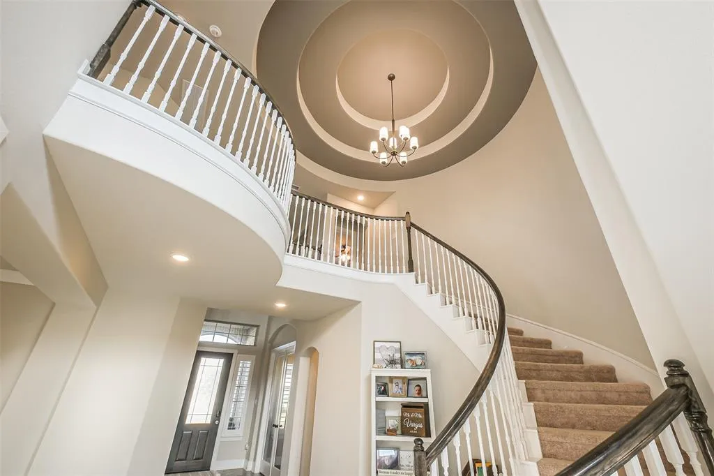 A large white staircase with a round ceiling.