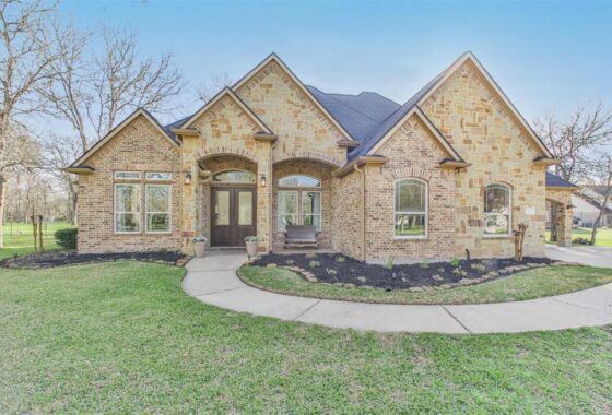 A large brick home with a circular driveway.