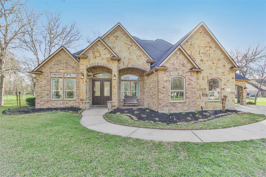 A large brick home with a circular driveway.