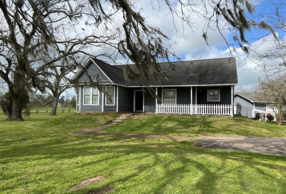 A house with a lot of grass in front