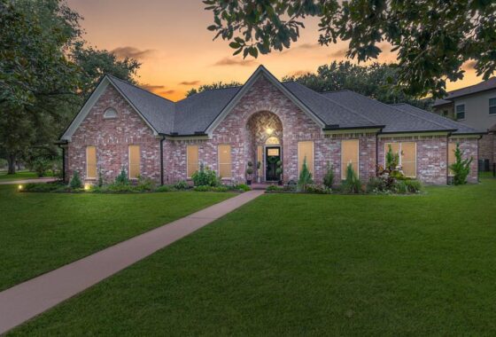 A large brick house with a lot of windows and doors.