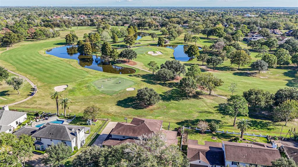 A view of some houses and trees from above.