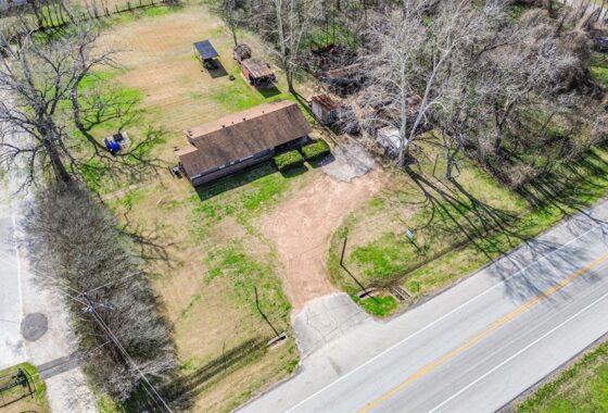 An aerial view of a house and some trees