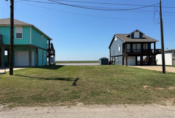 A couple of houses that are on the grass.