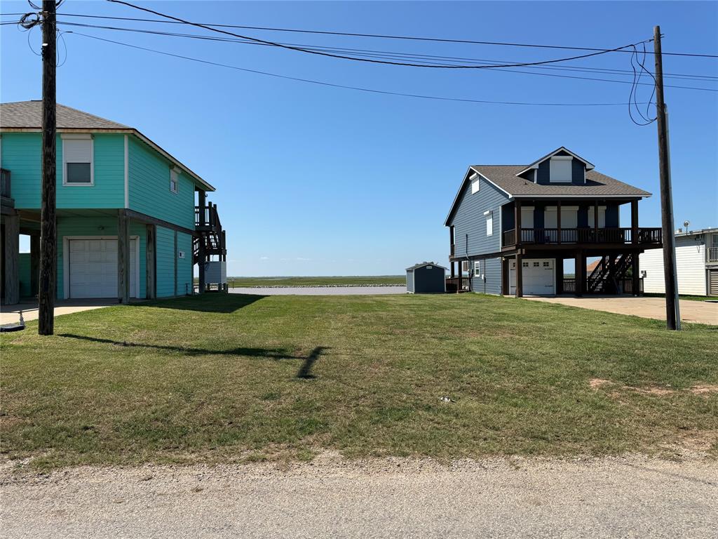 A couple of houses that are on the grass.